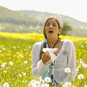 woman with allergies in field